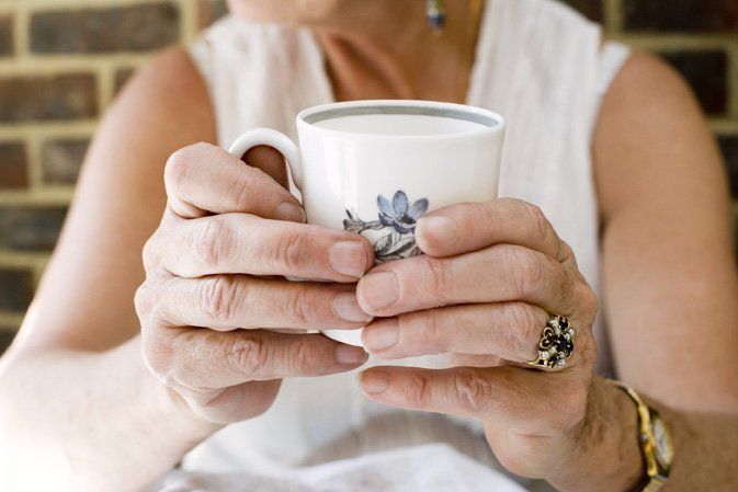 Hands holding a cup of tea
